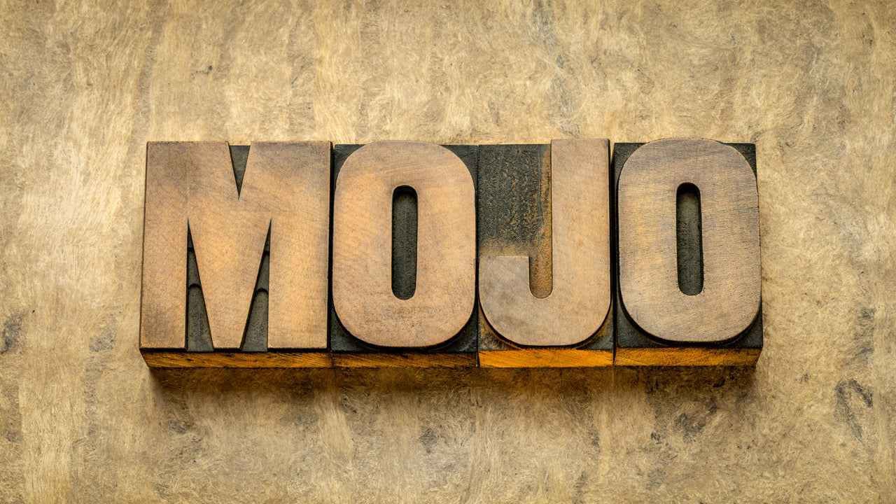 The word mojo is spelled out in wooden blocks against a similarly coloured background.